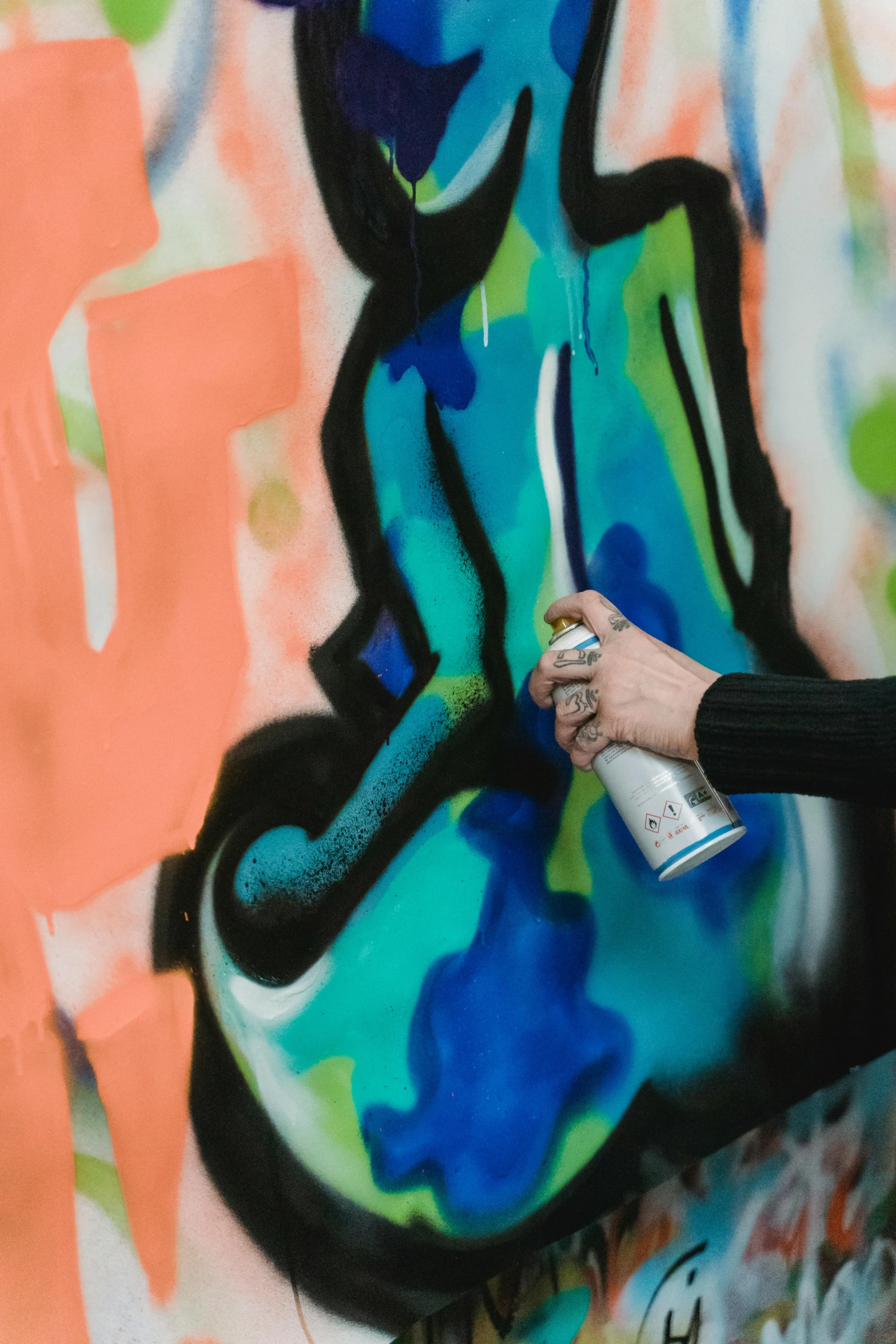 a woman spray painting graffiti on a wall, by Julia Pishtar, trending on unsplash, chartreuse and orange and cyan, 144x144 canvas, black graffiti, hyperrealist