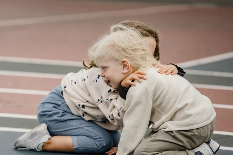 a couple of kids sitting on top of a tennis court, by Anita Malfatti, pexels contest winner, hugging her knees, toddler, lachlan bailey, owen klatte