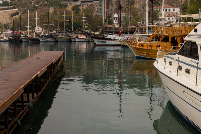 a number of boats in a body of water, by Doug Wildey, pexels contest winner, hurufiyya, docked at harbor, byzantine, brown, thumbnail