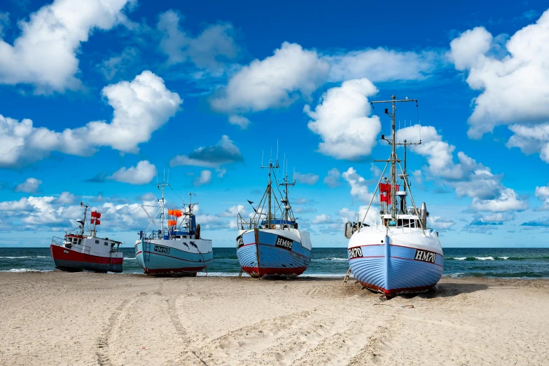 a group of boats sitting on top of a sandy beach, by Andries Stock, pexels contest winner, fish seafood markets, lower saxony, profile image, thumbnail