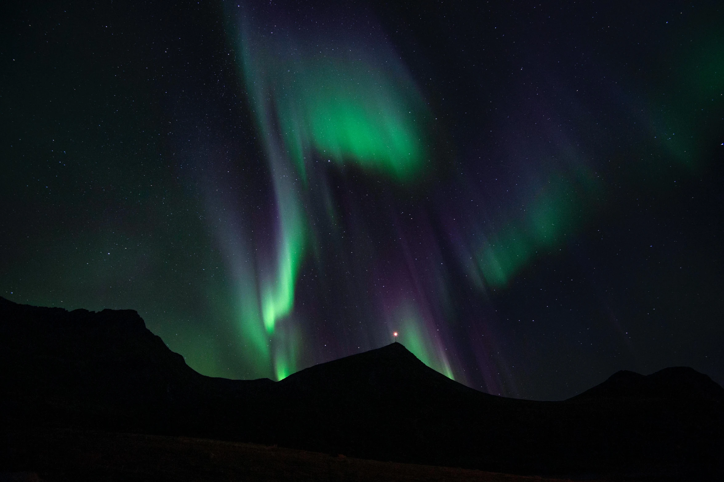the aurora lights up the sky above a mountain, by Hallsteinn Sigurðsson, pexels contest winner, hurufiyya, purple and green, elegant light, teal lights, 2022 photograph