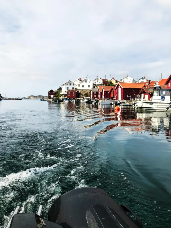 a boat traveling through a body of water, a picture, inspired by Wilhelm Marstrand, happening, white buildings with red roofs, 4k photo”, thumbnail, documentary photo