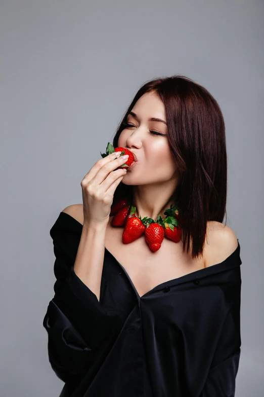 a woman in a black dress eating a strawberry, russian and japanese mix, 5 0 0 px models, wearing choker, 0 0 0