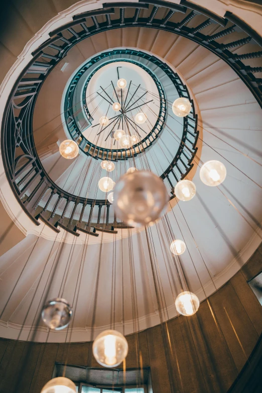 a spiral staircase with a clock on the top, honeycomb halls, exceptional lighting, palladian