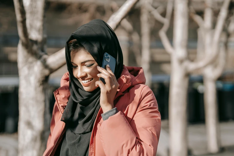 a woman in a hijab talking on a cell phone, trending on pexels, hurufiyya, fan favorite, black, pale-skinned persian girl, outdoor photo