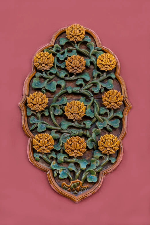 a close up of a decorative object on a wall, inspired by Pu Hua, chrysanthemums, symmetrical design, - 9, ornate wood