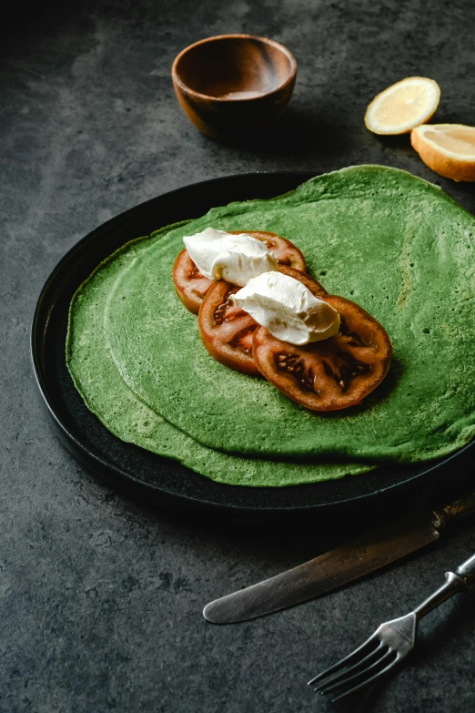 a close up of a plate of food on a table, dark green cloak, living food adorable pancake, no cropping, product image