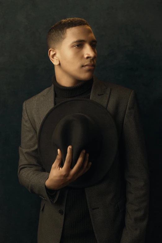 a man in a suit and hat poses for a picture, an album cover, inspired by Carlos Berlanga, trending on pexels, beautiful boy, profile pose, portrait of barack obama, andrew gonzalez