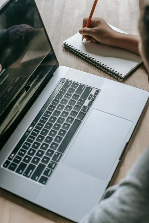 a person sitting in front of a laptop computer, pexels, high angle close up shot, multiple stories, rounded lines, maintenance