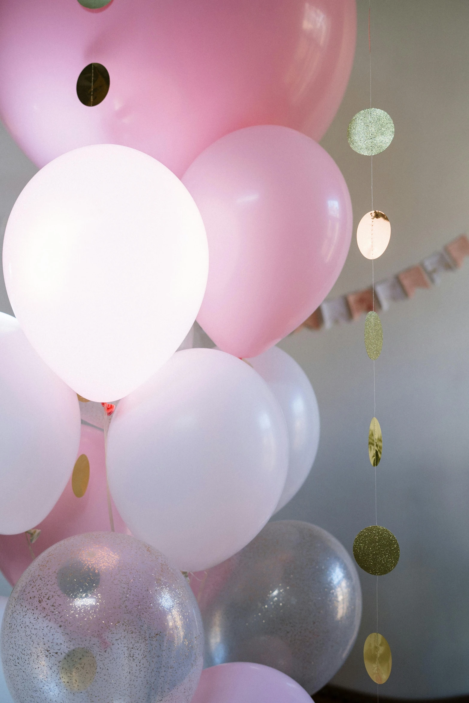 a bunch of balloons sitting on top of a table, light pink mist, detail shot, full colour, multiple stories