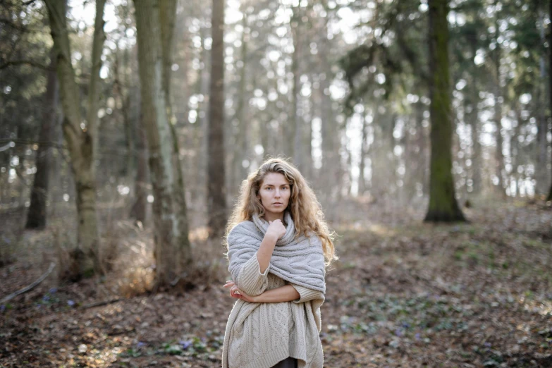 a woman standing in the woods wrapped in a blanket, a portrait, by Emma Andijewska, unsplash, happening, woman with braided brown hair, photoshoot for skincare brand, medium format. soft light, ((portrait))