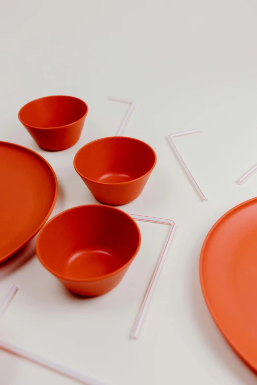 a close up of a plate and bowls on a table, by Doug Ohlson, plasticien, red and orange colored, award - winning design, different sizes, animation