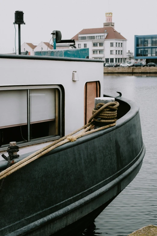 a boat sitting on top of a body of water, by Jan Tengnagel, trending on unsplash, modernism, side view close up of a gaunt, low quality photo, industries, portrait photo