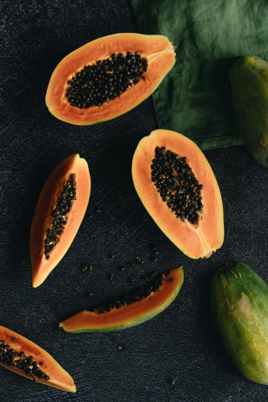 a bunch of papanas sitting on top of a table, by Matthias Stom, trending on unsplash, hurufiyya, orange and black, gestation inside a watermelon, seeds, sub tropical