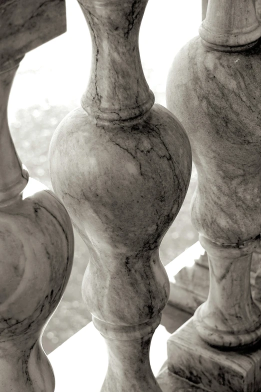 a black and white photo of a set of stairs, a marble sculpture, inspired by Gian Lorenzo Bernini, unsplash, baroque, marbled veins, spires, brown, close-up photograph