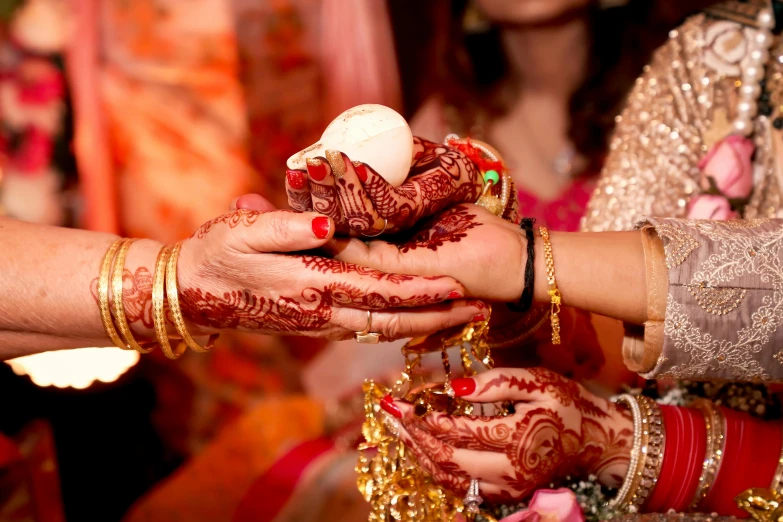 a close up of a person putting henna on another person's hand, a digital rendering, pexels, hurufiyya, square, bride, colourful, 2070