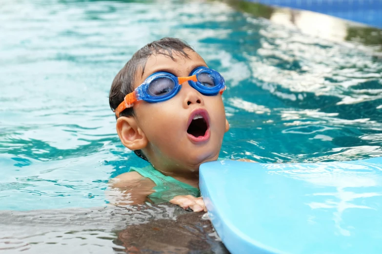 a little boy that is in the water with a frisbee, an album cover, shutterstock, square, pool tubes, thumbnail, tongue out