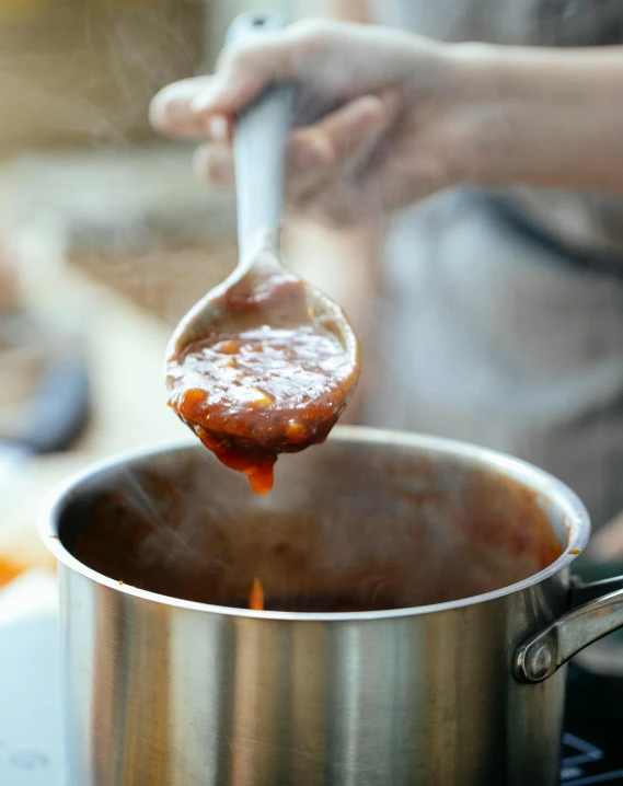 a person stirring something into a pot on a stove, pexels contest winner, process art, tomato sauce, al fresco, square, banner
