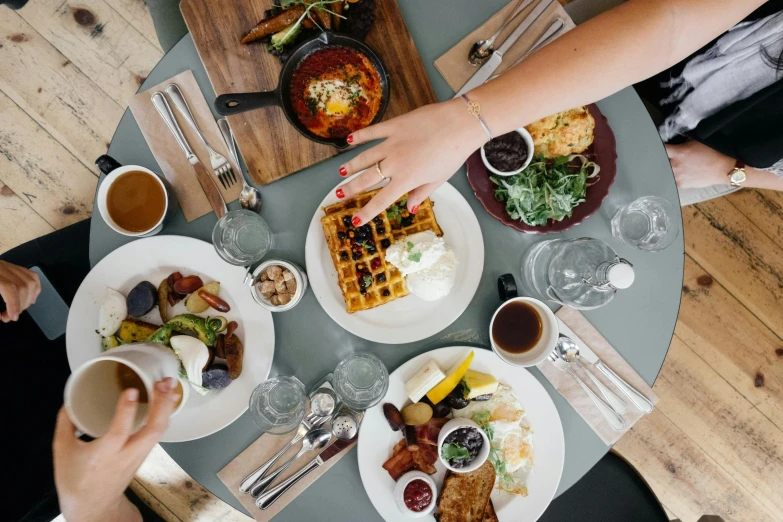 a group of people sitting at a table with plates of food, by Carey Morris, pexels contest winner, deconstructed waffle, 🦩🪐🐞👩🏻🦳, about to consume you, walking down