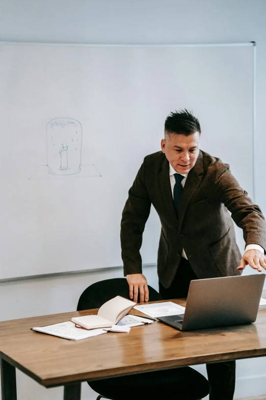 a man standing in front of a laptop computer, pexels contest winner, renaissance, standing in class, business suit, teaching, non-binary