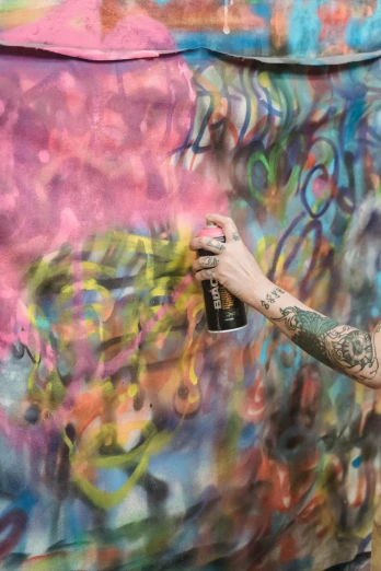 a man painting on a wall with a spray can, by artist, pexels contest winner, shed iridescent snakeskin, lesbian art, photograph of a sleeve tattoo, woman