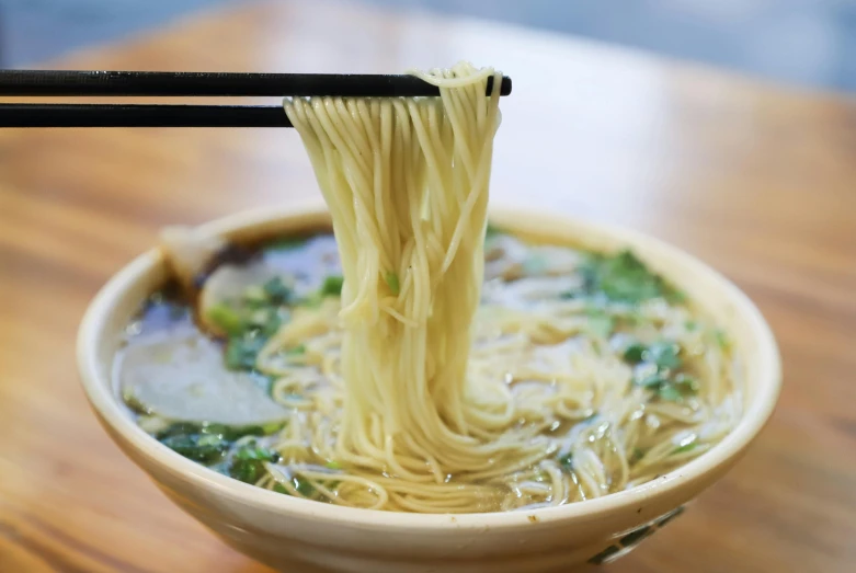 a bowl of noodles with chopsticks in it, inspired by Tan Ting-pho, mingei, zezhou chen, black