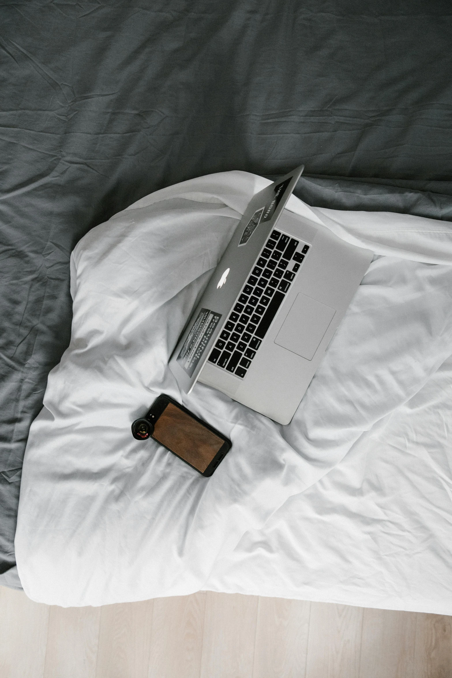 a laptop computer sitting on top of a bed, pexels, curled up under the covers, phone photo, casually dressed, hardware