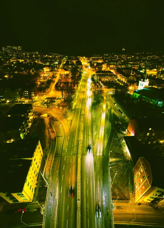 an aerial view of a city at night, an album cover, by Adam Marczyński, pexels contest winner, happening, highways, panoramic, yellow lights, scandinavian