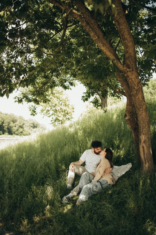 a man and a woman sitting under a tree, a picture, unsplash contest winner, renaissance, lush field, making out, reclining, full length shot