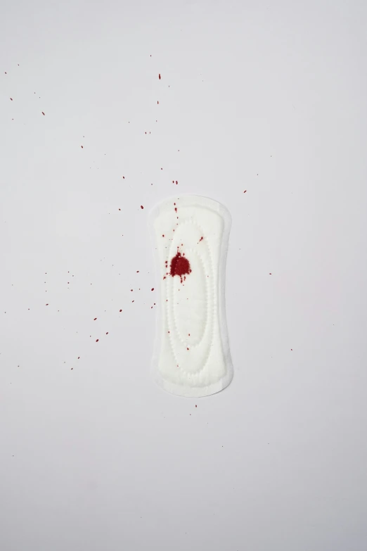 a white object with a blood stain on it, contracept, hasselblatt, soft pads, photographed for reuters