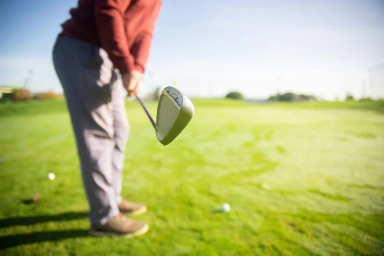 a man that is standing in the grass with a golf club, pexels contest winner, soft surfaces, avatar image, dynamic angled shot, half image