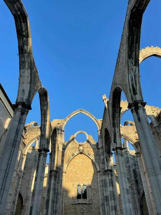 a view of the inside of a cathedral, an album cover, pexels contest winner, romanesque, clear blue skies, lisbon, ruins, youtube thumbnail