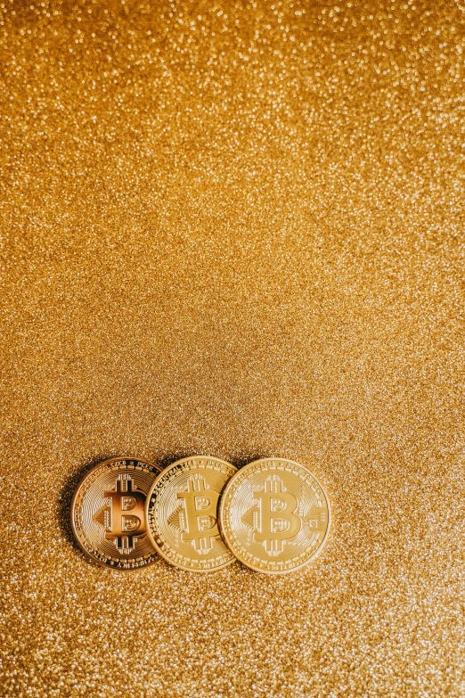 two bitcoins on a gold background, by Adam Marczyński, trending on unsplash, renaissance, glitter, photograph credit: ap, panel, three quater notes