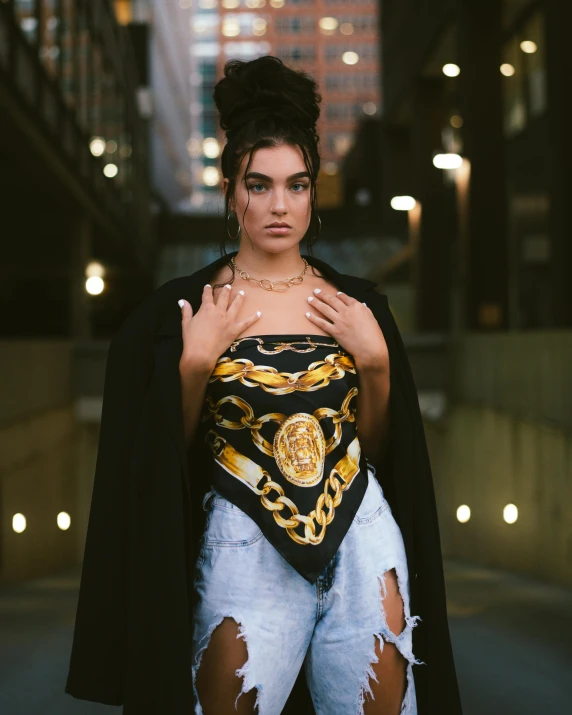 a woman standing in the middle of a city street, an album cover, inspired by Elsa Bleda, trending on pexels, renaissance, metal chain and black cape, madison beer girl portrait, regal and proud robust woman, non binary model
