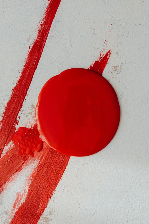 a close up of a red object on a white surface, a minimalist painting, inspired by Shōzō Shimamoto, trending on pexels, antoni tapies and cy twombly, big red sun, portrait made of paint, realistic paint