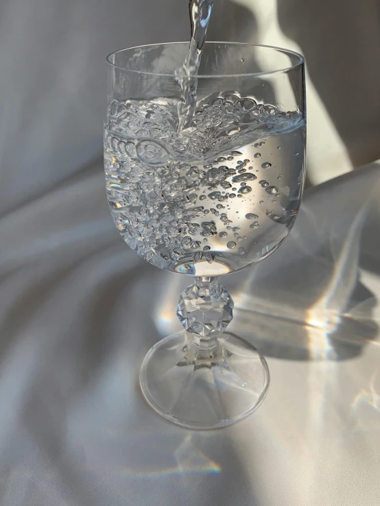 a glass of water being poured into a wine glass, by Isabel Naftel, hyperrealism, rinko kawauchi, intricate highly detailed 8 k, vintage aesthetic, wavy water