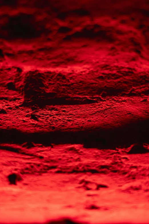 a close up of a red light in a room, inspired by Hubert Robert, cave glowing stones, ground red meat, 4 0 mm, brilliantly coloured