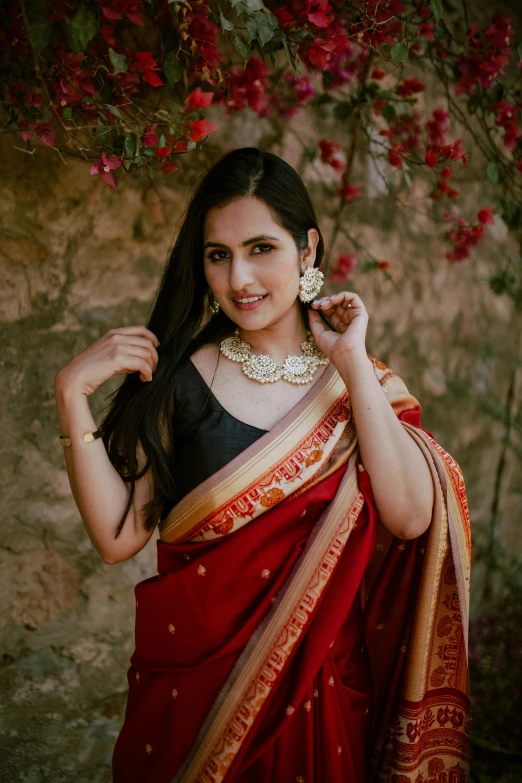 a woman wearing a red and gold sari, an album cover, pexels contest winner, square, wearing an elegant outfit, yael shelbia, at college