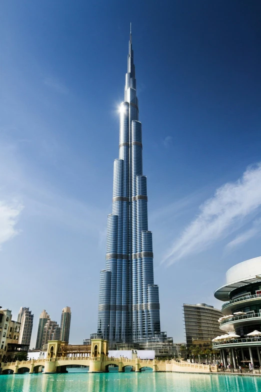 the burjra tower towering over the city of dubai, an album cover, 4k photo”, 8k resolution”, architecture and more, f/1.4