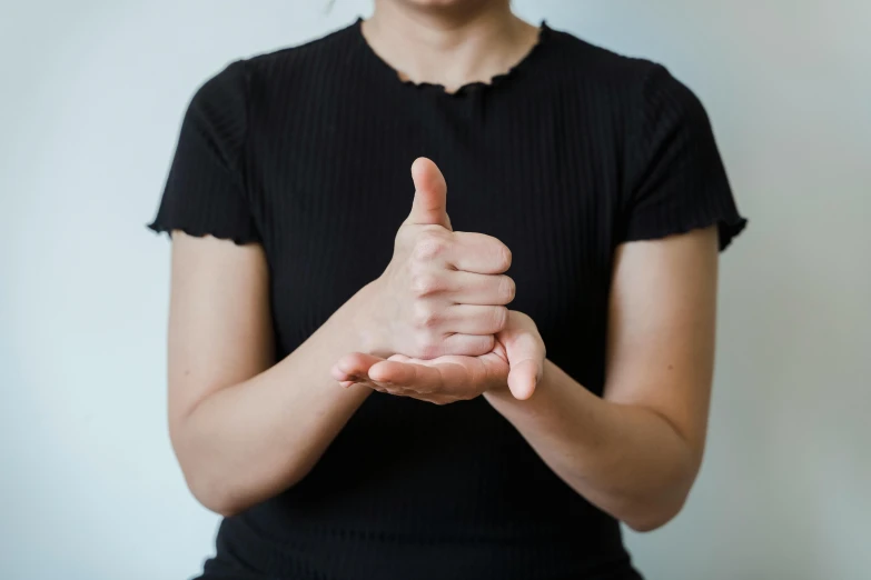 a close up of a person giving a thumbs up, by Emma Andijewska, naturalistic technique, t pose, small, physical