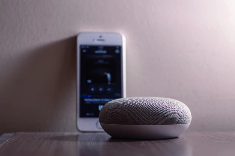 a smart device sitting on top of a wooden table, trending on pexels, bauhaus, speakers, brick, spherical, white