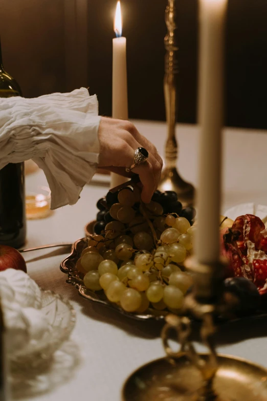 a close up of a plate of food on a table, inspired by Caravaggio, renaissance, grapes, elegant scene, movie filmstill, cellar