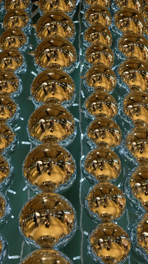 a bunch of cups sitting on top of a table, an album cover, inspired by Bruce Munro, pexels, golden orbs, macro up view metallic, stereogram, 8k detail