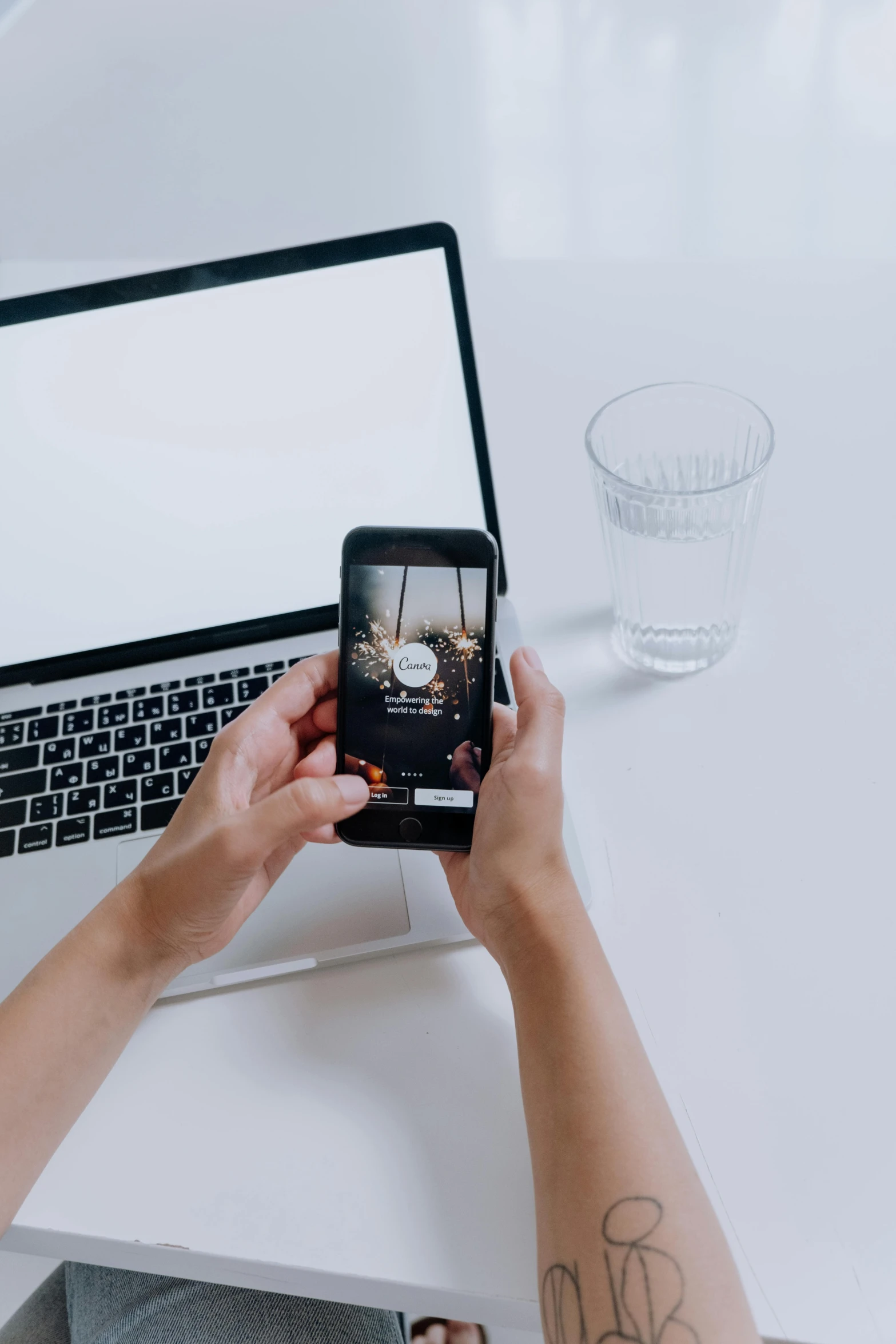 a person sitting at a table with a laptop and a cell phone, a picture, product image, trending on tiktok, centered shot, plain background