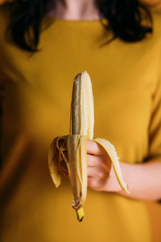 a close up of a person holding a banana, holding intimately, standing straight, intimate, highly capsuled