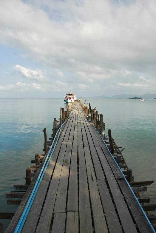 a long wooden pier stretching out into the ocean, happening, bao pnan, july 2 0 1 1, moored, 8 k -
