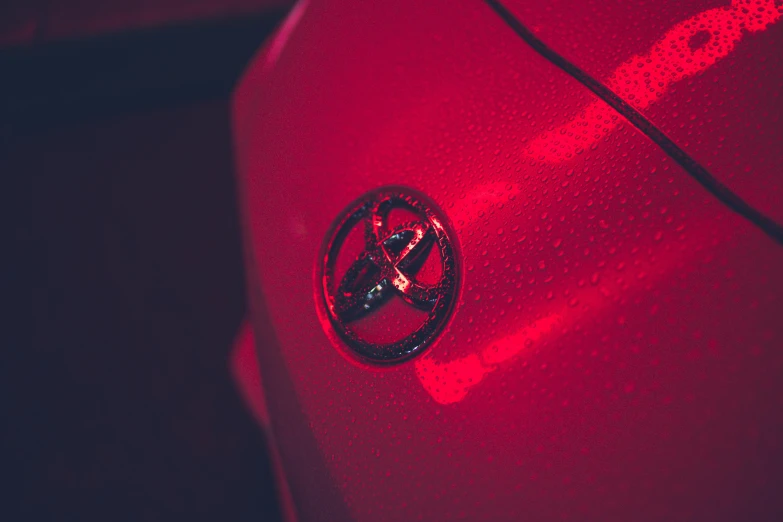 a close up of a car with a red light, pexels contest winner, precisionism, toyota supra, emblem of wisdom, high resolution print :1 red, avatar image