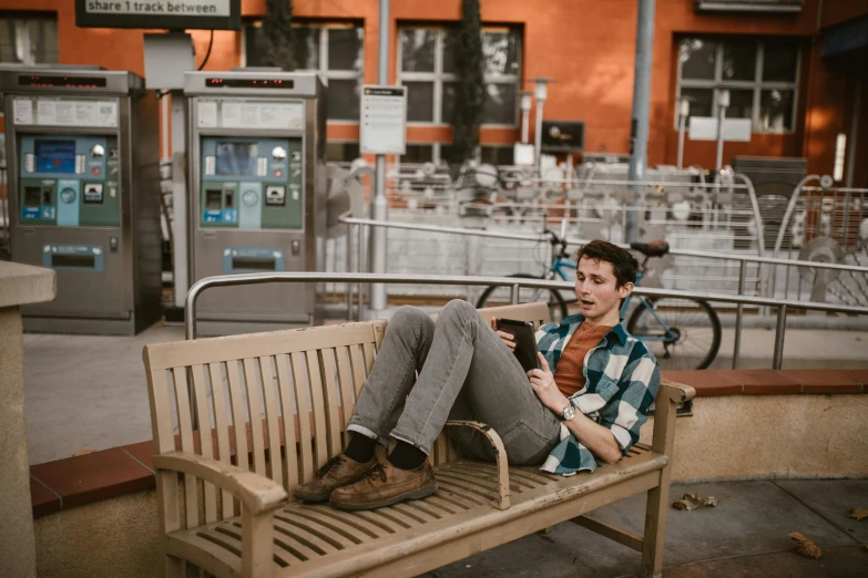 a person sitting on a bench with a dog, by mads berg, pexels contest winner, happening, bus station, avatar image, handsome man, orange line