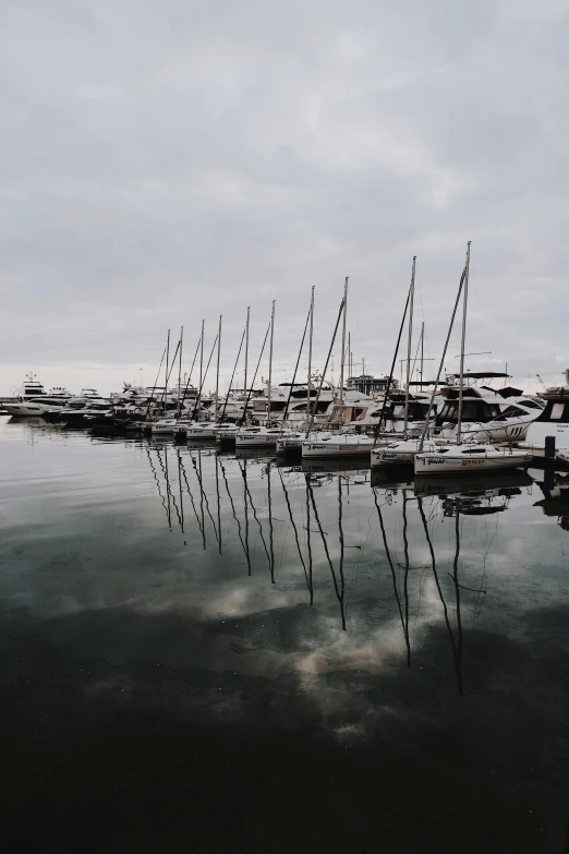 a bunch of boats that are sitting in the water, a picture, pexels contest winner, overcast gray skies, bored ape yacht club, 1 6 x 1 6, trending on vsco