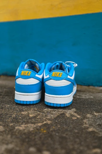 a pair of blue and white shoes sitting on the ground, thumbnail, kickflip, neon blue, size